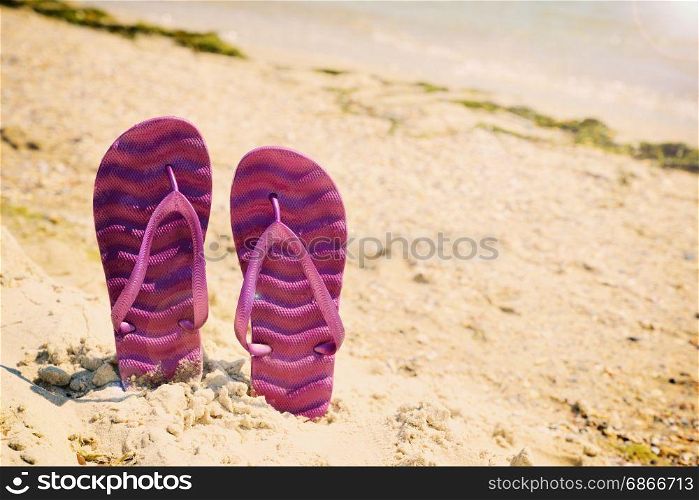Purple beach slippers on the beach, vintage toning