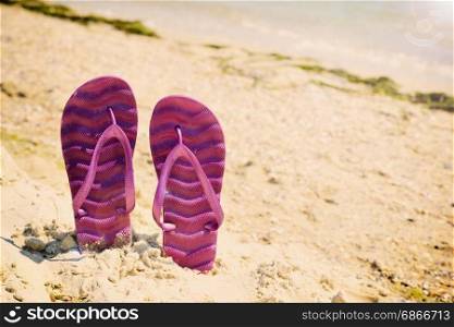 Purple beach slippers on the beach, vintage toning