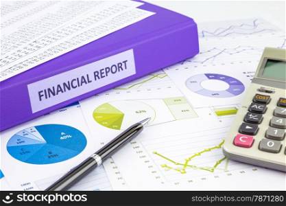 Purple binder of financial report place on graphs and charts analysis or business reports, concept to budget management