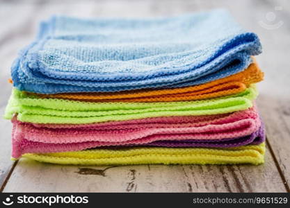 Purple, blue, pink, orange, green,yellow napkins on white wooden background