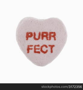 Purple candy heart that reads purrfect against white background.