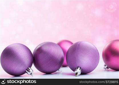 purple christmas balls over blurred background
