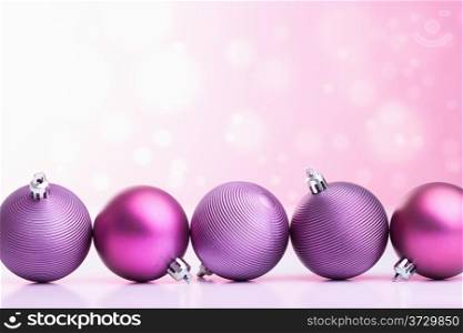 purple christmas balls over blurred background