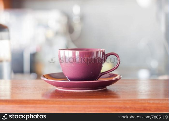 Purple coffee cup in coffee shop, stock photo