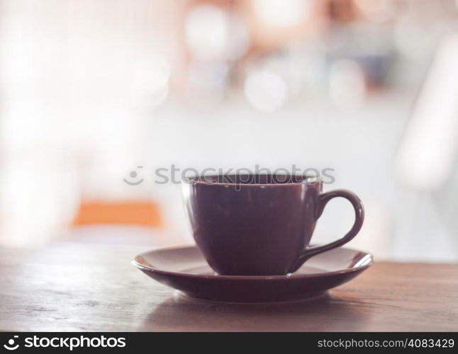 Purple coffee cup on wooden table, stock photo