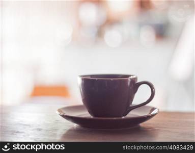 Purple coffee cup on wooden table, stock photo