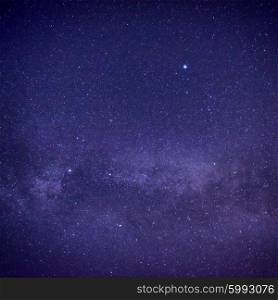 Purple dark night sky with many stars. Space milky way background