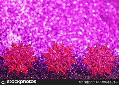Purple decorative christmas snowflakes on glitter background with copy space