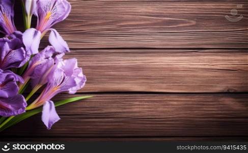 Purple iris flowers on wooden background. Space for text.