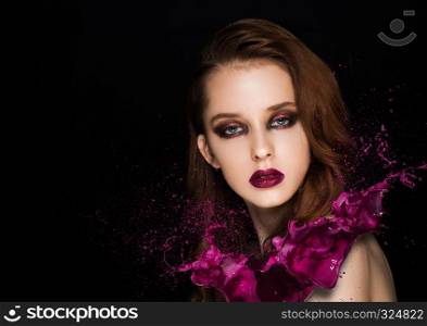 Purple paint splash over beauty makeup model girl with purple smokey eyes abstract on black background