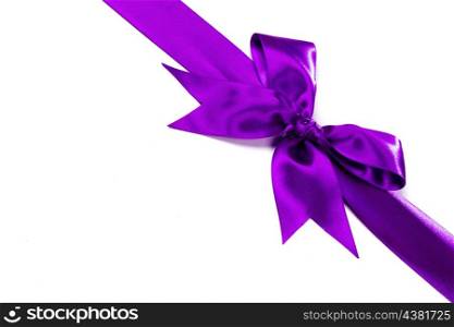 Purple ribbon with bow isolated on white background