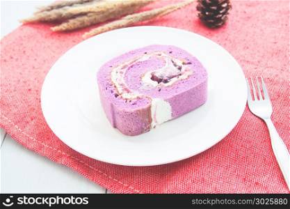Purple roll cake made from blueberry with cream