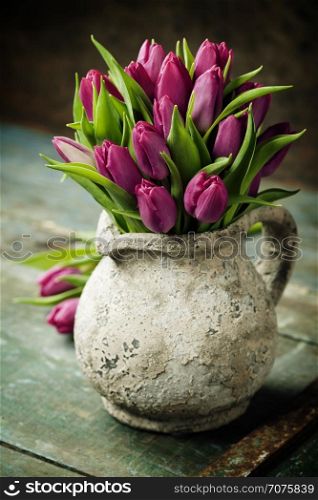 Purple Tulips on a wooden surface. Studio photography
