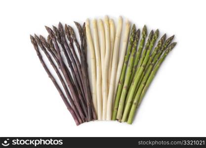 Purple, white and green asparagus on white background