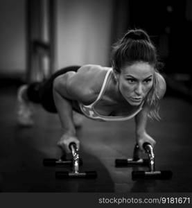 Push-up strength training, woman doing push-ups in the gym.  . Push-up strength training