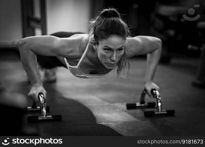 Push-up strength training, woman doing push-ups in the gym.  . Push-up strength training