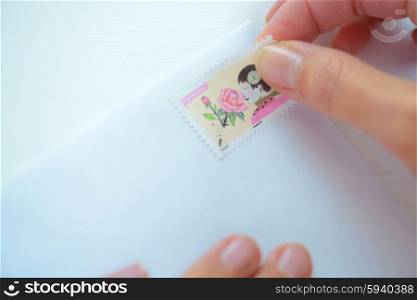 Putting a stamp on a letter