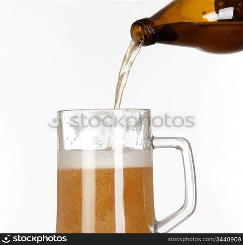 Putting beer in a glass jar on white background isolated