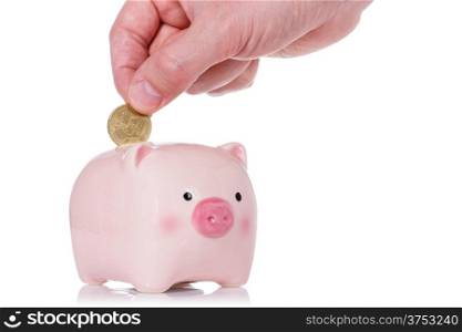 Putting fifty cent into the piggy bank isolated on white background