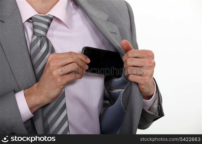 Putting mobile into his pocket