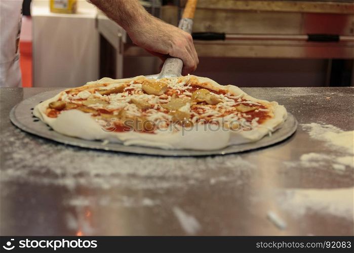 Putting Raw Pizza into Oven with Spatula, Italian Mushrooms Pizza Preparation