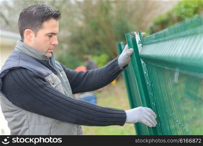 Putting up a metal fence in the garden