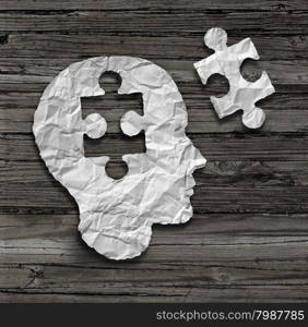 Puzzle head brain concept as a human face profile made from crumpled white paper with a jigsaw piece cut out on a rustic old wood background as a mental health symbol.