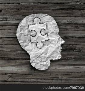 Puzzle head solution concept as a human face profile made from crumpled white paper with a jigsaw piece cut out inside the brain area on an old wood background as a mental health symbol.