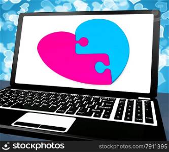 . Puzzle Heart On Laptop Showing Online Dating And Romance