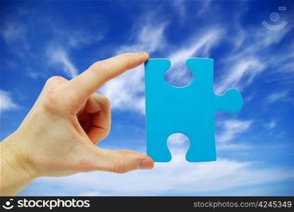 puzzle in hand isolated on sky background