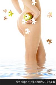 puzzle of naked woman with green apple in water