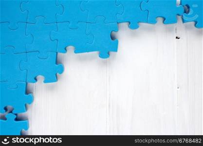 Puzzle on white wooden background.Team business concept
