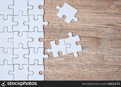 puzzle pieces on wood table background. Business solutions, mission target, successful, goals, cooperation, partnership and strategy concept