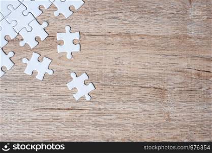 puzzle pieces on wood table background. Business solutions, mission target, successful, goals, cooperation, partnership and strategy concept
