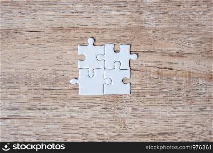 puzzle pieces on wood table background. Business solutions, mission target, successful, goals, cooperation, partnership and strategy concept