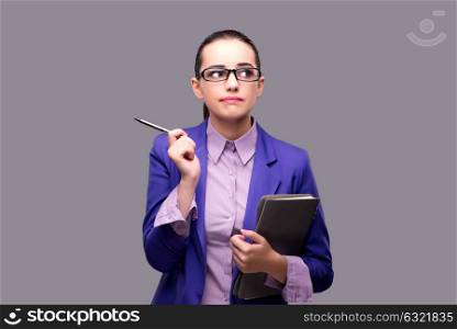 Puzzled businesswoman on gray background
