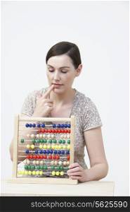 Puzzled Woman Using Abacus