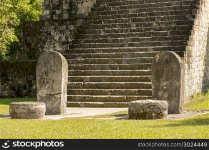 Pyramid and stele in the Complex Q area of the Mayan ruins at Tikal, Guatemala