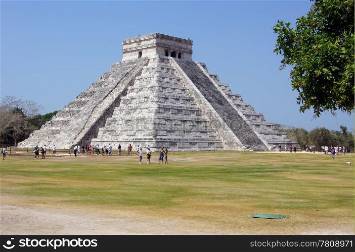 Pyramid Kukulkan and tourists on the square in Chichen Itza, Mexico
