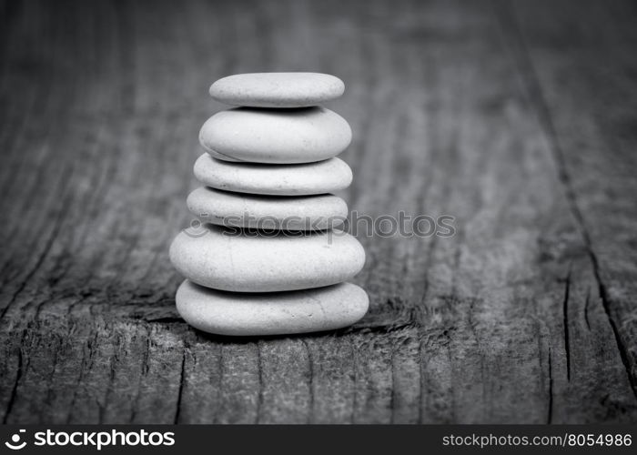 Pyramid of zen stones on a wooden board