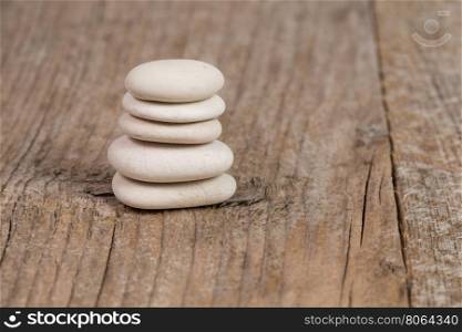 Pyramid of zen stones on a wooden board