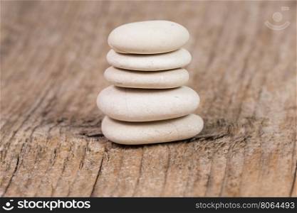 Pyramid of zen stones on a wooden board