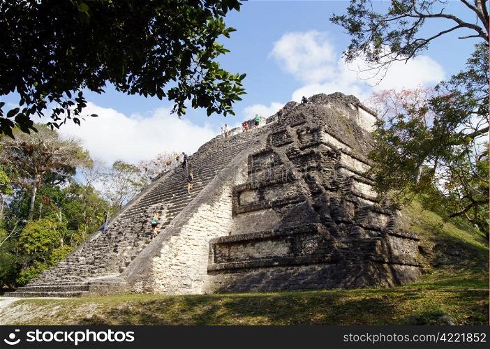 Pyramid with tourists and forest in Tikal, Guatemala