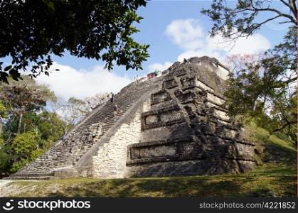 Pyramid with tourists and forest in Tikal, Guatemala