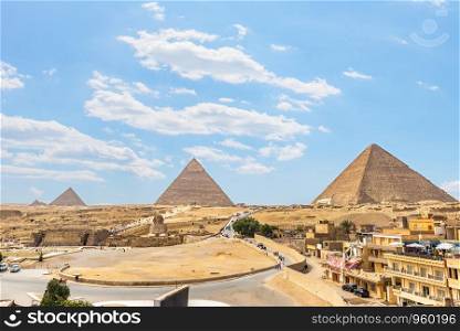 Pyramids and Sphinx on Giza plateau in desert of Egypt, view from above. Pyramids of plateau Giza