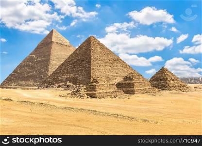 Pyramids of pharaos and queens under blue cloudy sky. Pyramids of pharaos and queens