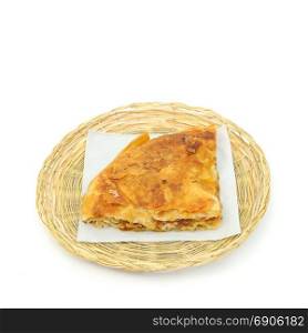 Pzza burek or pie on a paper serviette in a wicker or bread basket over white background
