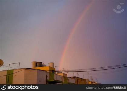 Qawra, Malta 30. may 2019 - rainbow over the residential buildings.. Qawra, Malta 30. may 2019 - rainbow over the residential buildings