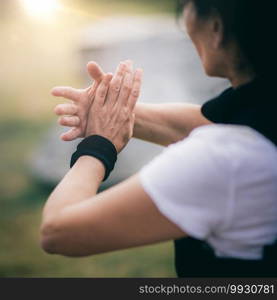 Qi Gong training outdoors, woman’s hands in focus.. Chi Gong Practice