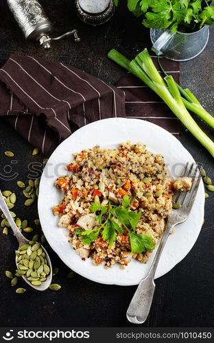 qinoa porridge with vegetables on white plate